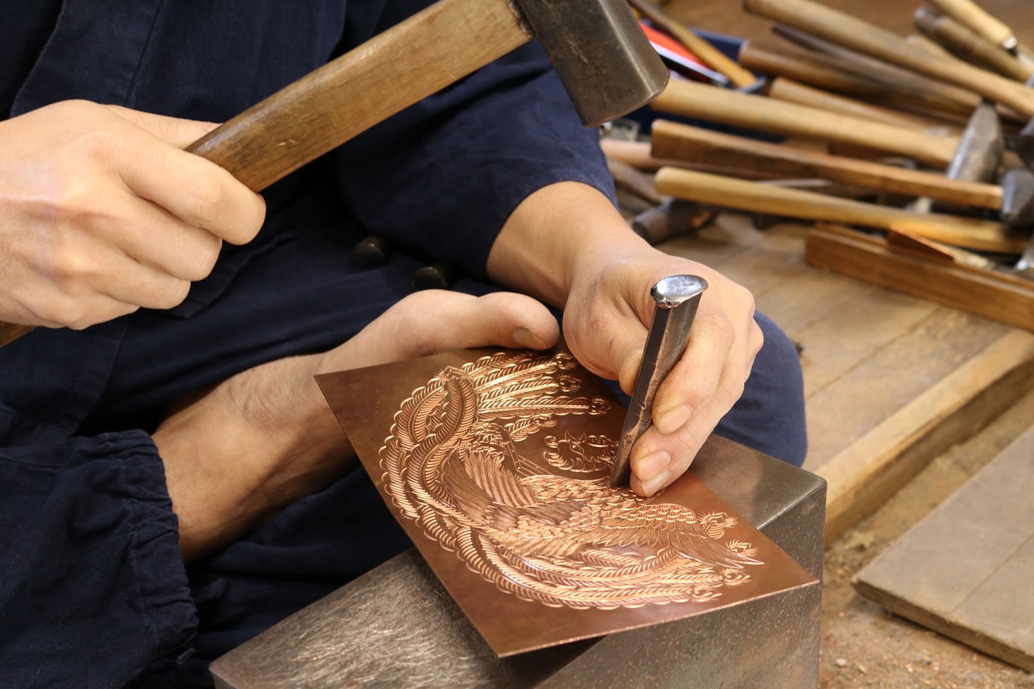 金具をトンカチで打ち、模様を刻む様子